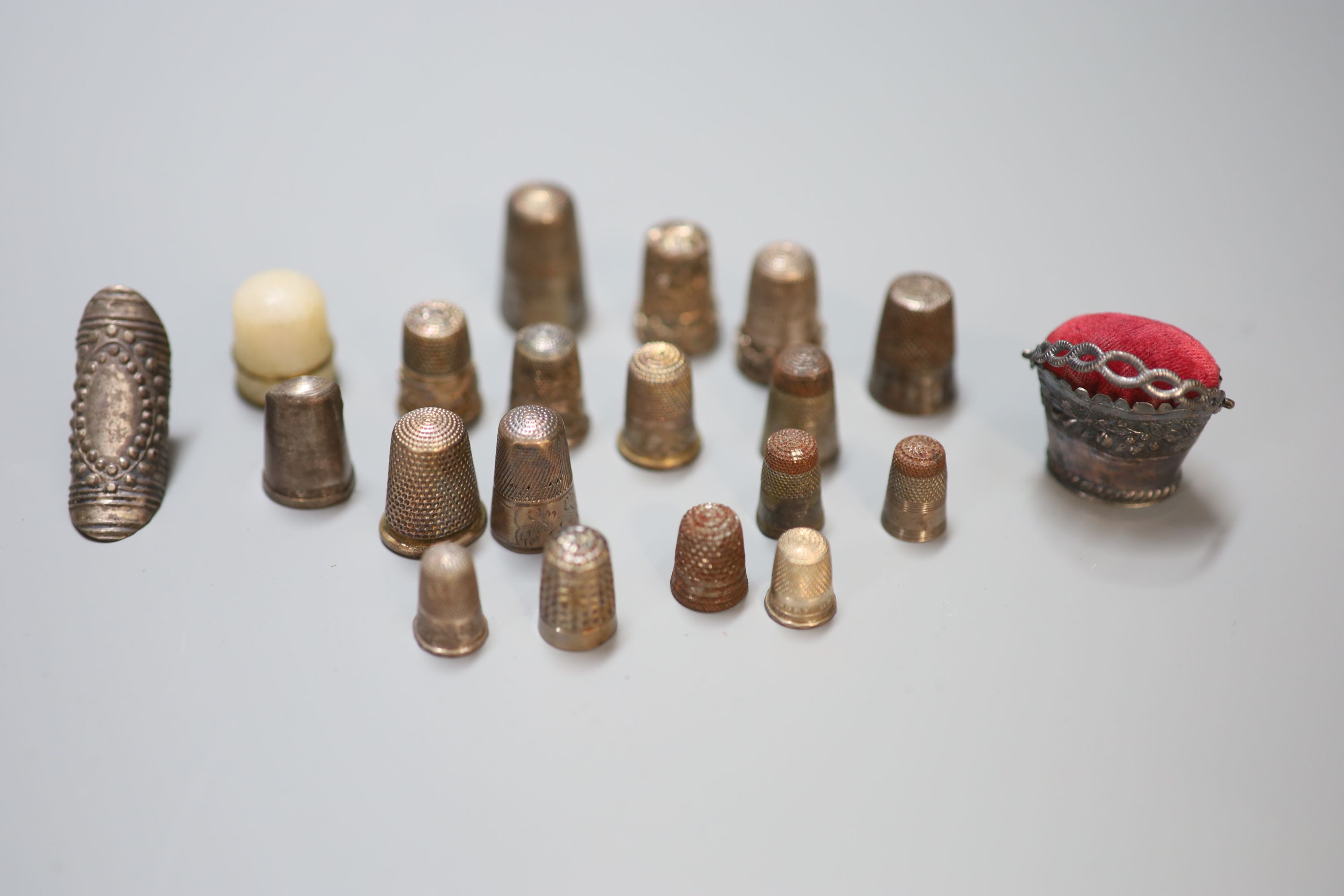 A collection of assorted thimbles and other sewing accessories